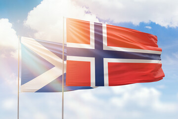 Sunny blue sky and flags of norway and scotland