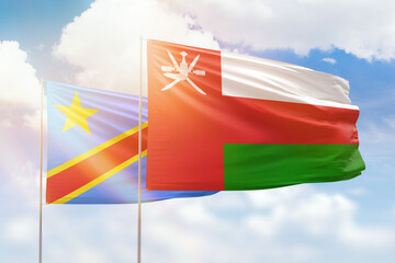 Sunny blue sky and flags of oman and dr congo