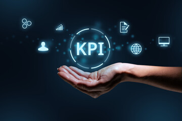 Concept KPI or Key Performance Indicator. Business acronym. Holographic text and icons over hand