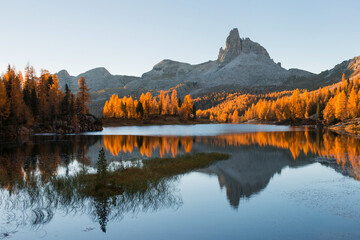 Amazing autumn scenery in the Dolomites mountains by the Lake Federa in the fall. National Unesco park in Italy.
