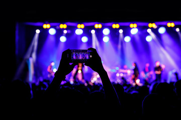 Streaming a music concert to social media via smartphone.