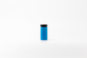 Blue plastic bottle, black cap, isolated with white background, engraved