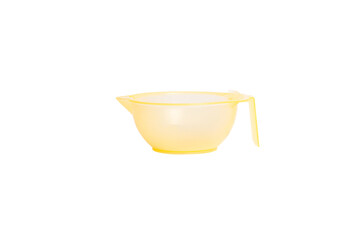 plastic bowl for hair coloring or manicure. on white background measuring cup, hairdressing supplies, yellow, hair dye bowl
