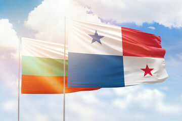 Sunny blue sky and flags of panama and bulgaria