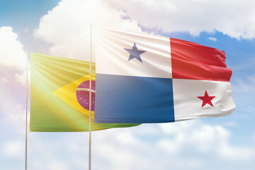 Sunny blue sky and flags of panama and brazil