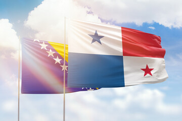 Sunny blue sky and flags of panama and bosnia