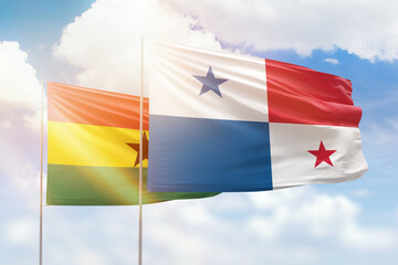 Sunny blue sky and flags of panama and ghana