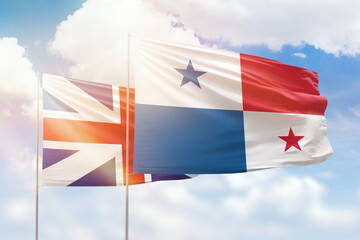 Sunny blue sky and flags of panama and great britain