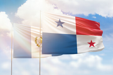 Sunny blue sky and flags of panama and guatemala