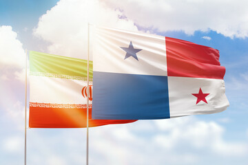 Sunny blue sky and flags of panama and iran