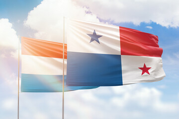 Sunny blue sky and flags of panama and luxembourg