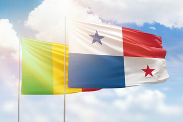 Sunny blue sky and flags of panama and mali