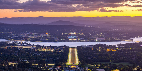 Canberra Australia viewed from Mount Ainslie at sunset looking down on the Australian War Memorial and ANZAC Parade towards Lake Burley Griffin with Parliament House behind and the suburbs of Canberra
