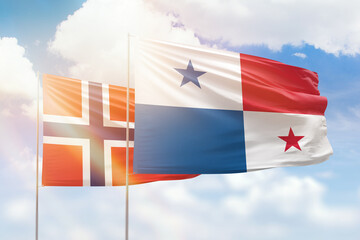 Sunny blue sky and flags of panama and norway