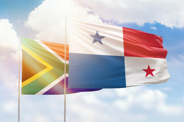 Sunny blue sky and flags of panama and south africa