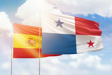 Sunny blue sky and flags of panama and spain