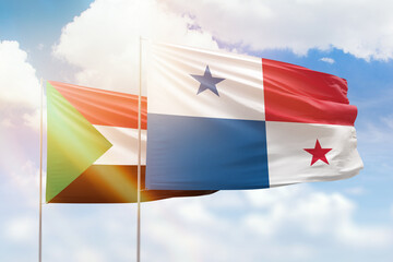 Sunny blue sky and flags of panama and sudan