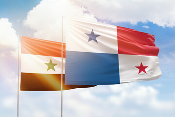 Sunny blue sky and flags of panama and syria