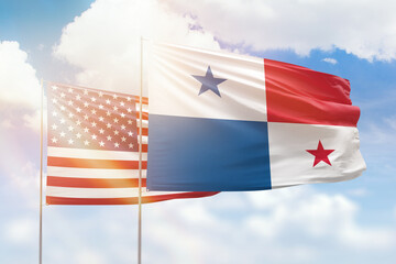 Sunny blue sky and flags of panama and usa