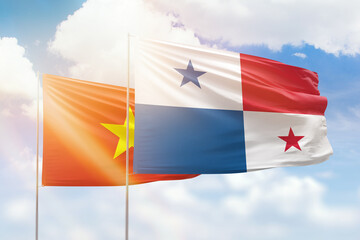 Sunny blue sky and flags of panama and vietnam