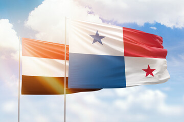 Sunny blue sky and flags of panama and yemen