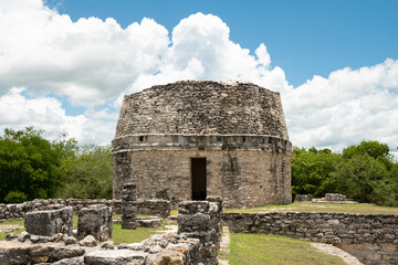 Fototapeta na wymiar Mayapan, Yucatan, Mexico: El Templo Redondo -- The Round Temple -- among the ancient Mayan ruins in Mayapan.