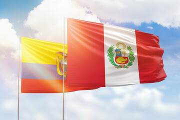Sunny blue sky and flags of peru and ecuador