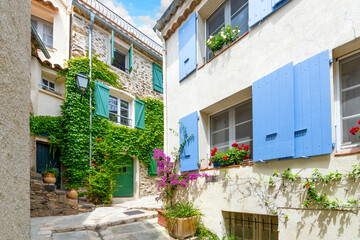 A charming, picturesque street in the medieval village of Grimaud, France, in the hills above Saint-Tropez along the French Riviera.