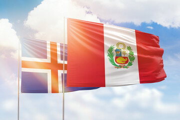 Sunny blue sky and flags of peru and iceland