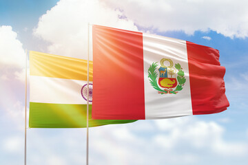 Sunny blue sky and flags of peru and india