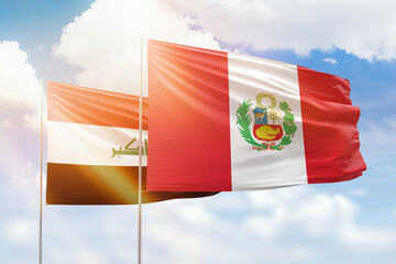 Sunny blue sky and flags of peru and iraq