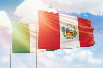 Sunny blue sky and flags of peru and nigeria