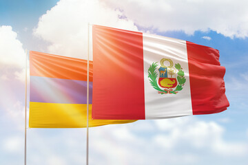 Sunny blue sky and flags of peru and armenia