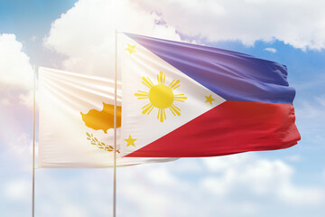 Sunny blue sky and flags of philippines and cyprus