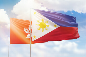 Sunny blue sky and flags of philippines and hong kong