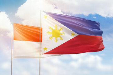 Sunny blue sky and flags of philippines and indonesia