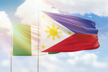 Sunny blue sky and flags of philippines and nigeria
