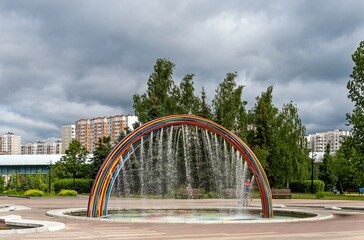 There is a fountain with colorful pipes in the city