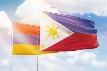 Sunny blue sky and flags of philippines and armenia