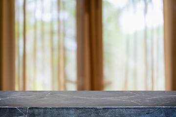 Empty black marble stone table top and blurred home interior with curtain window background with...