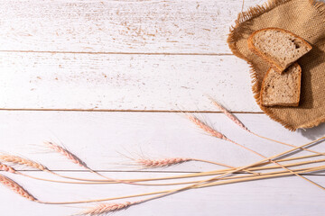 Bread ears and pieces of bread on a burlap on the table, a place for the text