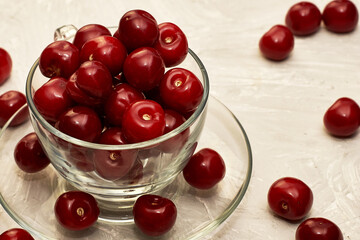 red ripe cherries in a teacup on the table