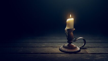 Antique brass candle holder with a burning candlestick on a dark wooden background. 3D rendering, illustration - 511803397