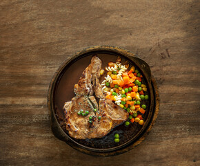 hot t-bone pork stake with vegetable with gravy sauce