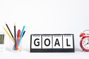 Goal or plan concepts with text on notepad and office accessories.Business management