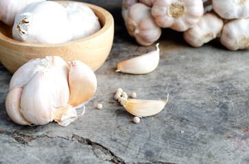 Garlic cloves on old wood table with macro close up for raw food backgrounds