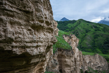 Bizarre forms of weathered sandstone in the mountains. The rocks are composed of sandstones and volcanic rocks. Caucasian Mountains.