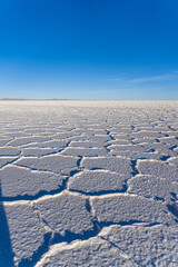 Obraz na płótnie Canvas Amazingly white salt flat landscape Salar de Uyuni, in the middle of the Andes in southwestern Bolivia, the world's largest salt flat scene with blue sky on a sunny day 2022