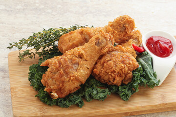 Fried chicken drumsticks with tomato sauce