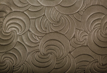 Texture of gray genuine leather with embossed floral trend pattern close-up, color, for wallpaper...